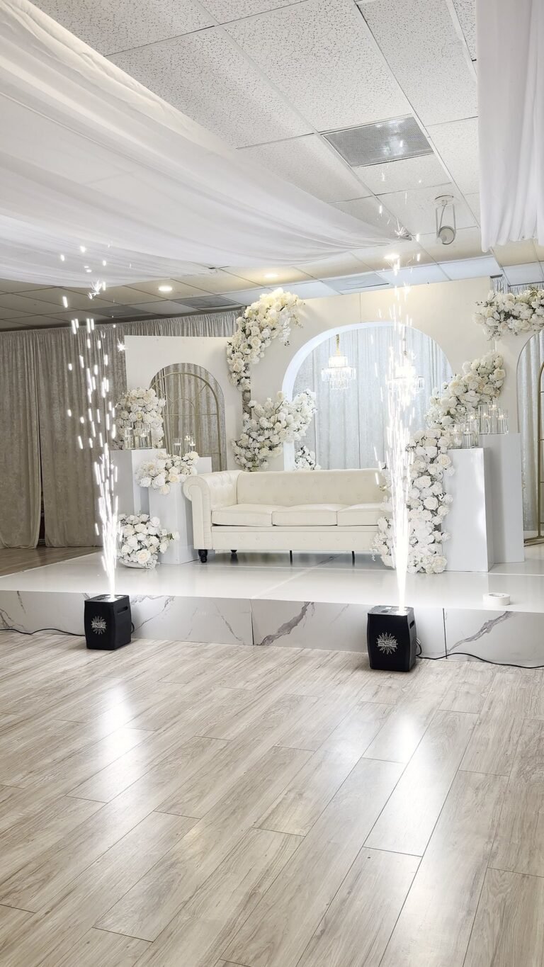 White floral arch and lounge seating staged in the ballroom at 5959 West wedding venue Orlando